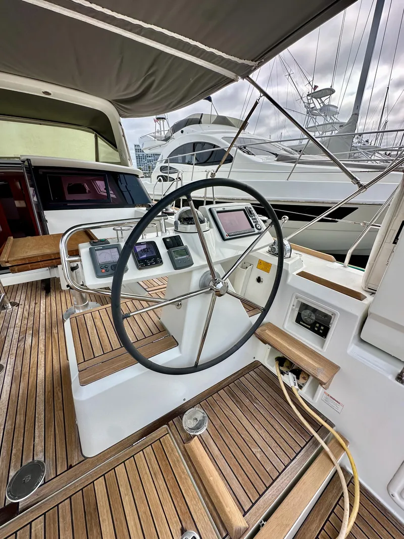 Slide: The Image of Cockpit of 2012 Beneteau Sense 43 yacht with steering wheel and navigation instruments. - 10