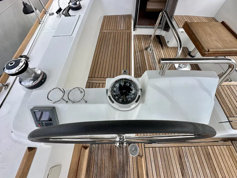 Slide: The Image of Steering wheel and compass on 2012 Beneteau Sense 43 yacht with teak decking. - 11