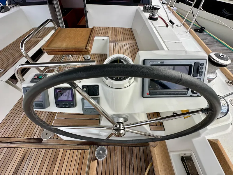 Slide: The Image of Steering wheel and navigation instruments on 2012 Beneteau Sense 43 yacht deck. - 14