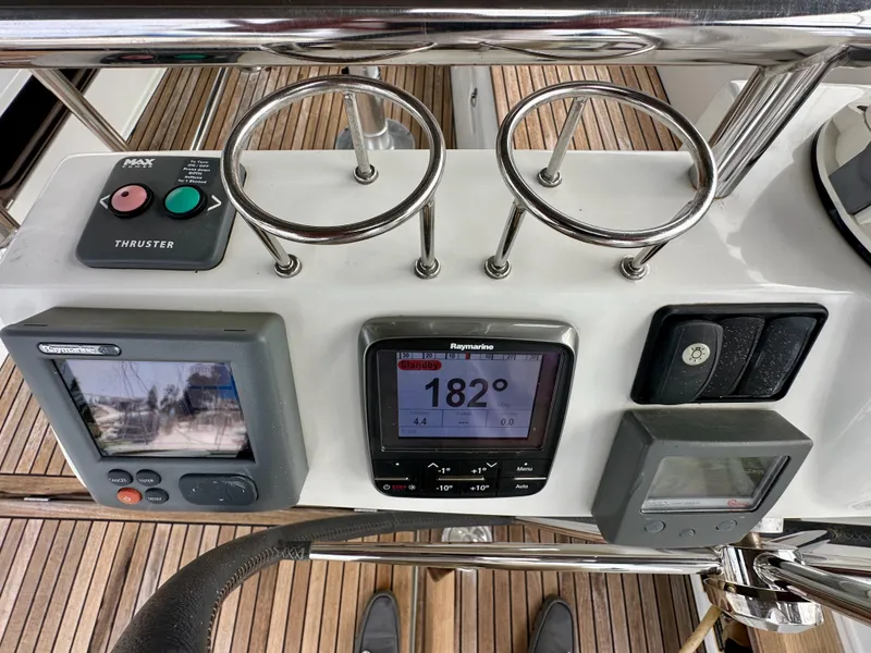 Slide: The Image of Beneteau Sense 43 yacht dashboard with navigation instruments and thruster controls, 2012 model. - 16