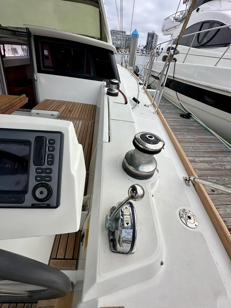 Slide: The Image of Cockpit view of a 2012 Beneteau Sense 43 yacht, featuring navigation controls and winch. - 18