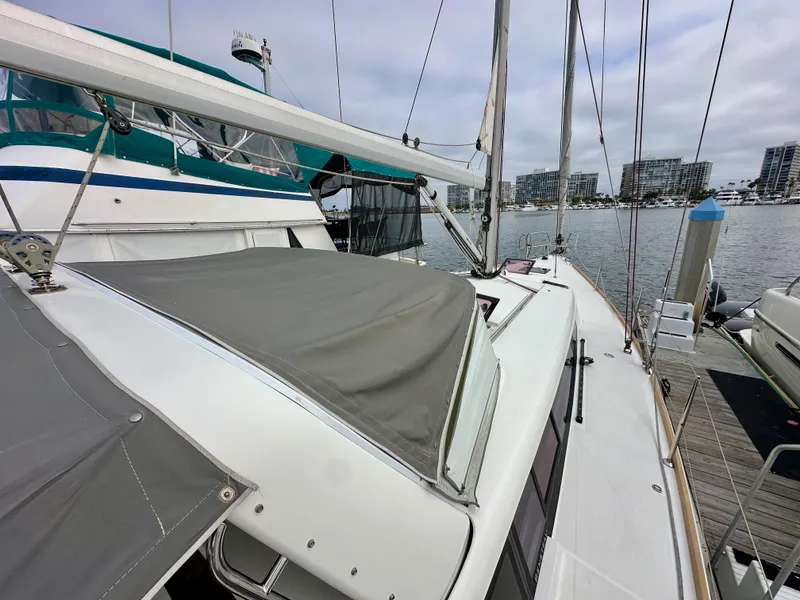 Slide: The Image of 2012 Beneteau Sense 43 sailboat docked at marina, showcasing deck and rigging. - 20