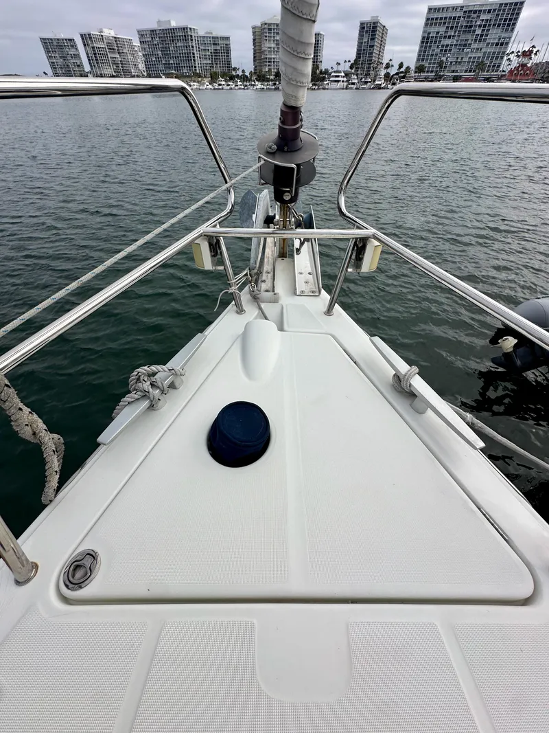 Slide: The Image of Bow of 2012 Beneteau Sense 43 yacht with city skyline in background. - 22