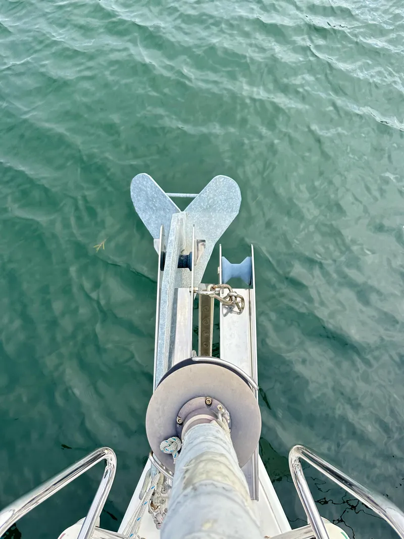 Slide: The Image of Bow view of 2012 Beneteau Sense 43 sailboat with anchor over water. - 24