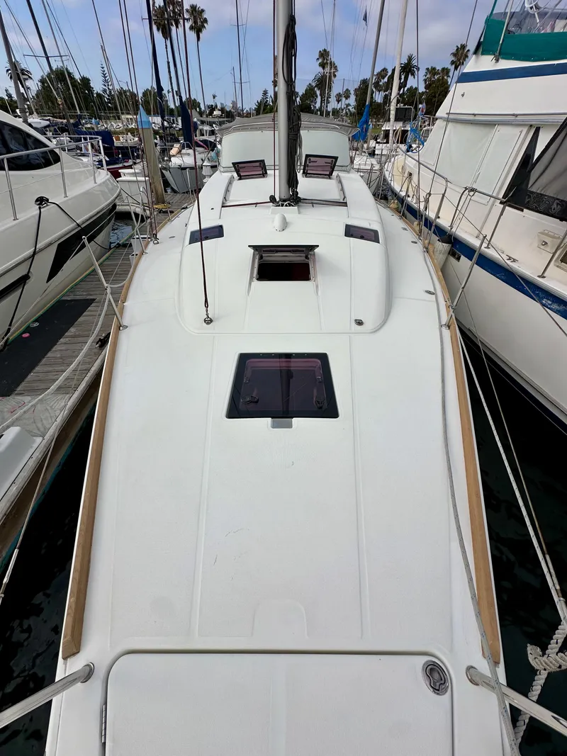 Slide: The Image of 2012 Beneteau Sense 43 sailboat docked at marina, top deck view. - 25