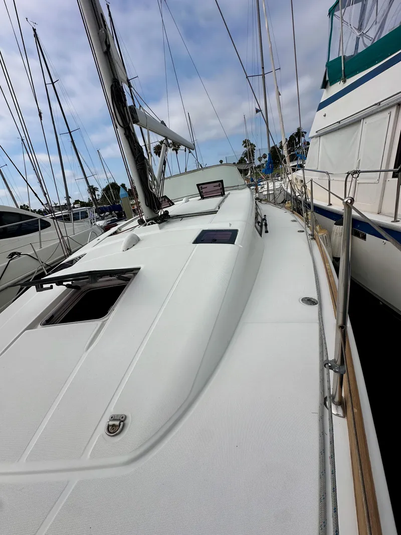 Slide: The Image of 2012 Beneteau Sense 43 sailboat deck view in marina setting. - 27