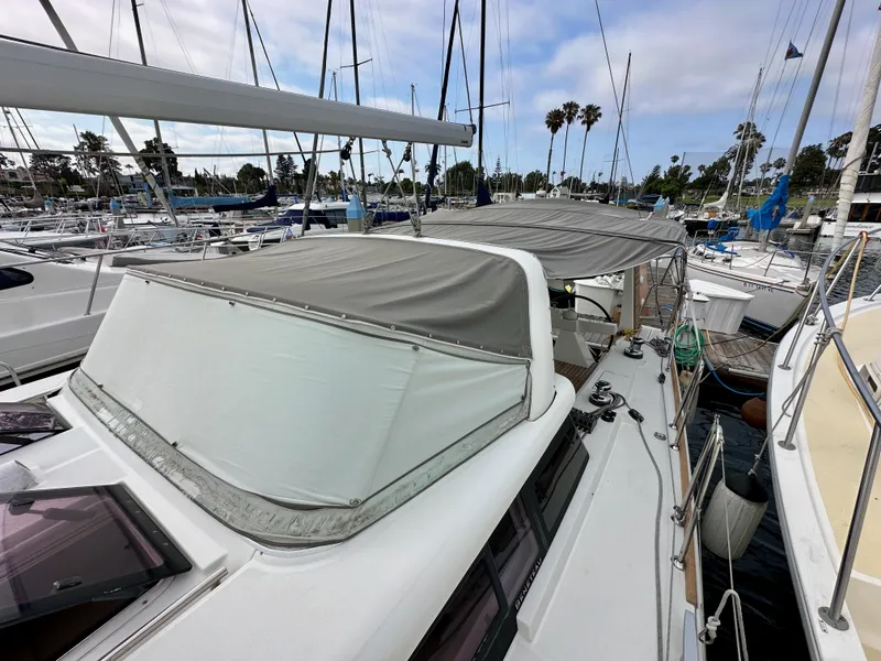 Slide: The Image of Beneteau Sense 43 sailboat, 2012 model, docked in a marina with canopy cover. - 30
