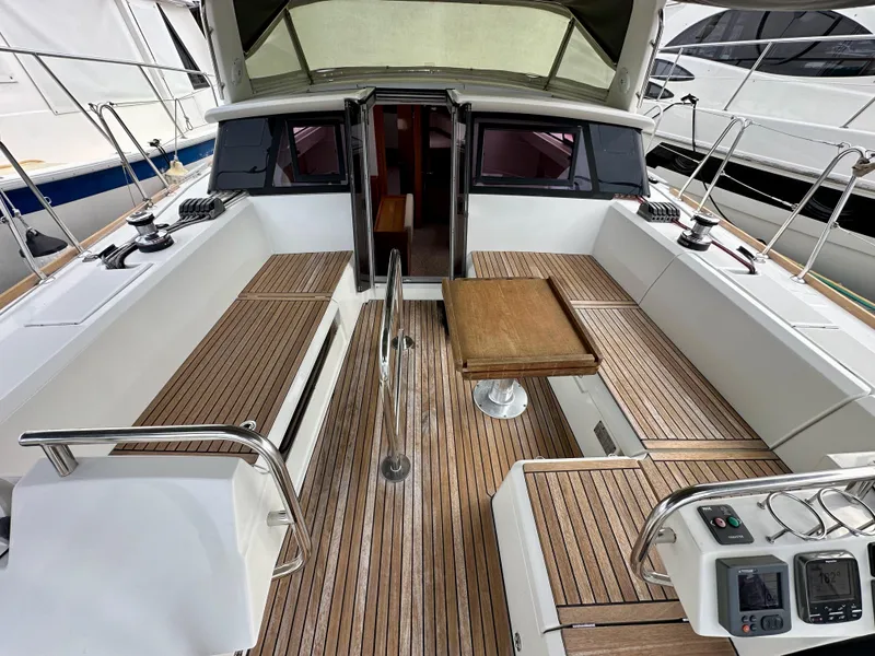 Slide: The Image of 2012 Beneteau Sense 43 yacht cockpit with teak flooring and seating area. - 33