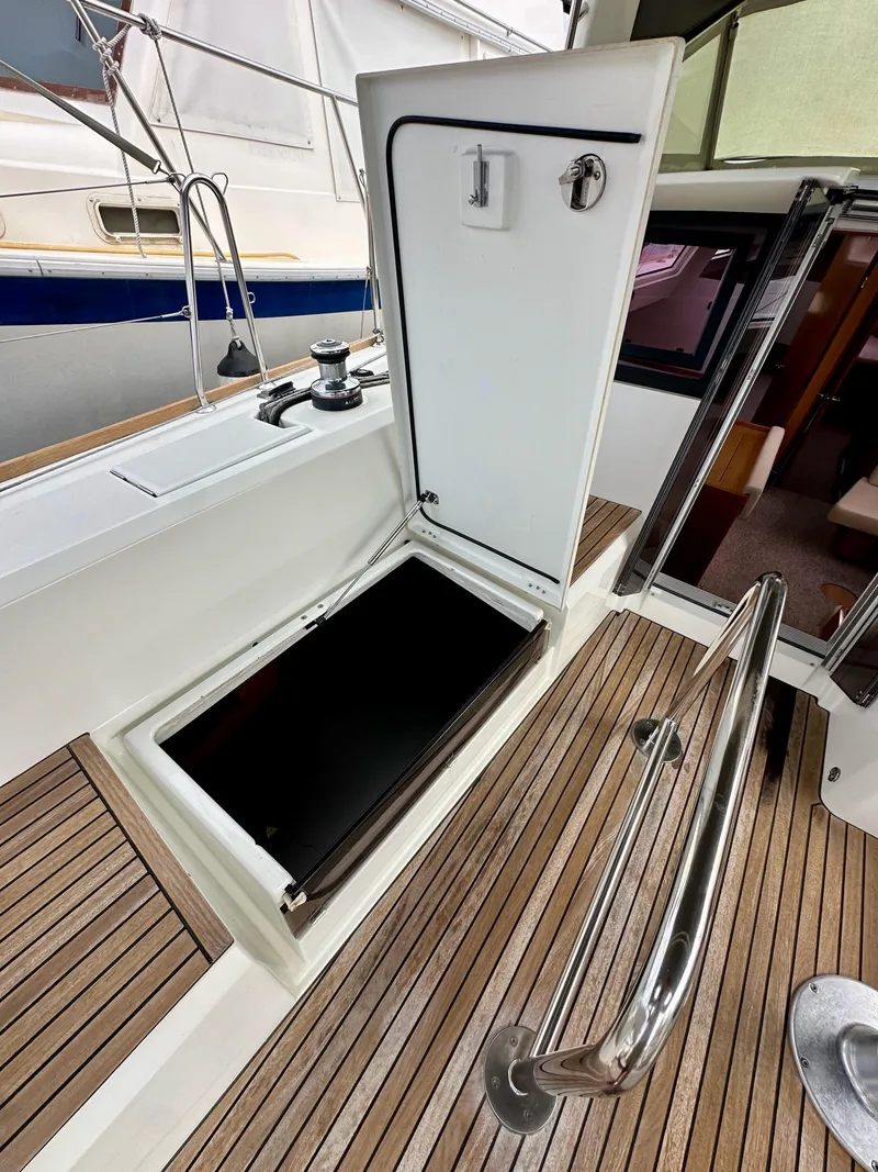 Slide: The Image of Beneteau Sense 43 yacht deck with open storage compartment, 2012 model. - 35