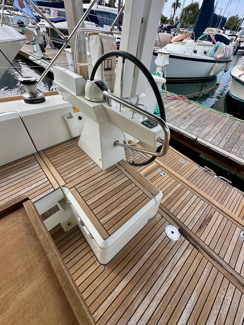 Slide: The Image of Steering wheel and deck of 2012 Beneteau Sense 43 yacht at marina. - 38