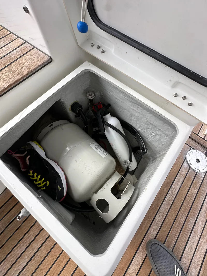 Slide: The Image of Storage compartment on a 2012 Beneteau Sense 43 yacht with propane tank and shoes. - 39