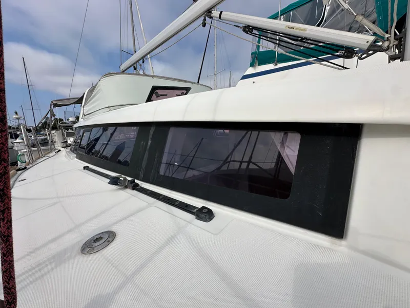 Slide: The Image of 2012 Beneteau Sense 43 sailboat deck with sleek windows and rigging. - 4