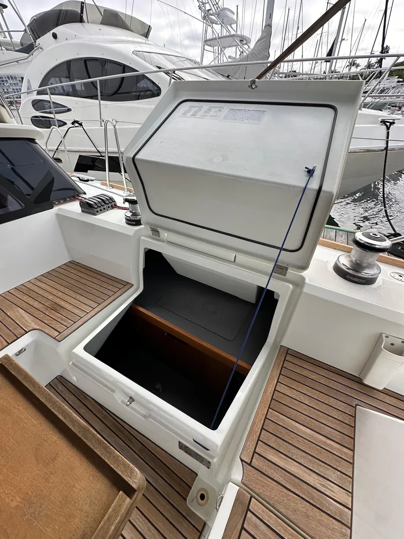 Slide: The Image of Open storage compartment on 2012 Beneteau Sense 43 yacht deck, featuring wooden flooring. - 40