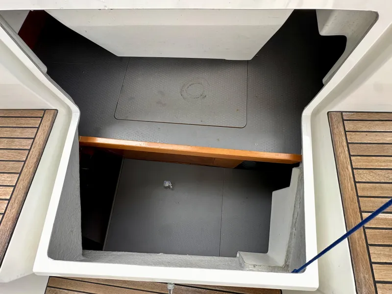 Slide: The Image of Interior view of 2012 Beneteau Sense 43 yacht with wooden flooring and storage compartment. - 41