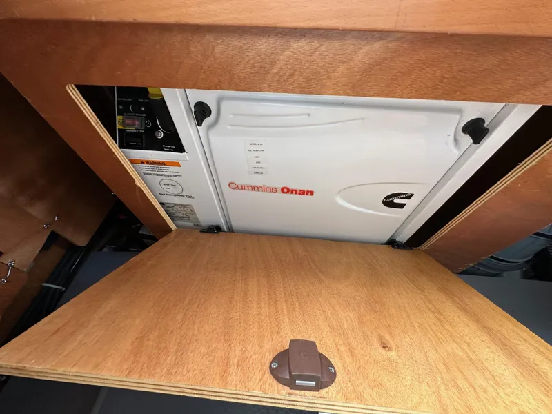 Slide: The Image of Cummins Onan generator in 2012 Beneteau Sense 43 yacht, wooden compartment view. - 43
