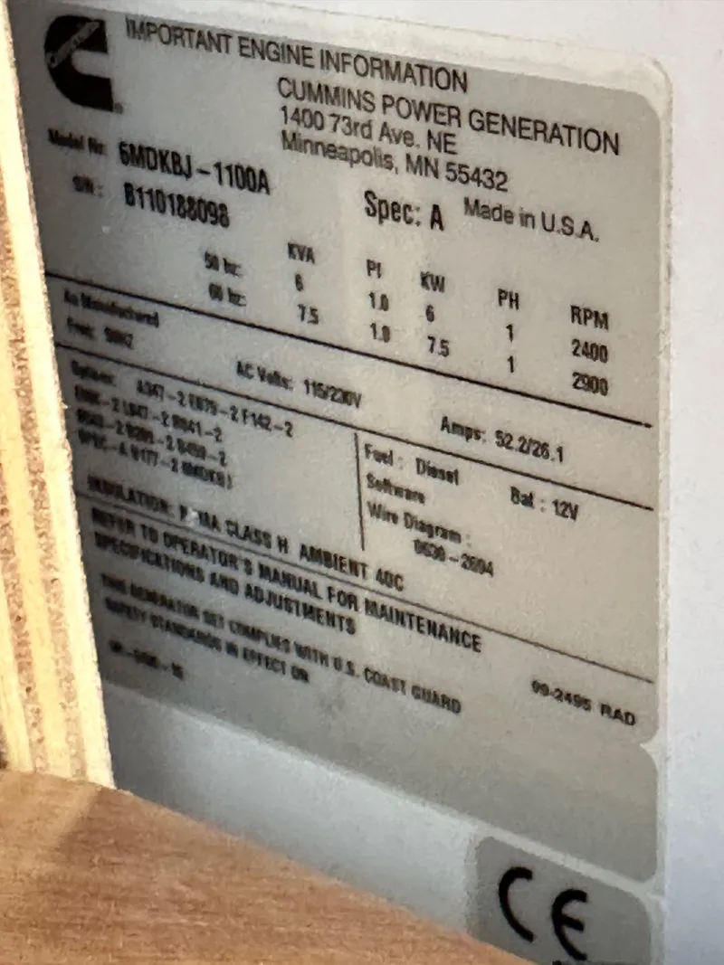 Slide: The Image of Label on Cummins generator, model 5MDKBJ-1100A, showing specifications and manufacturing details. - 44