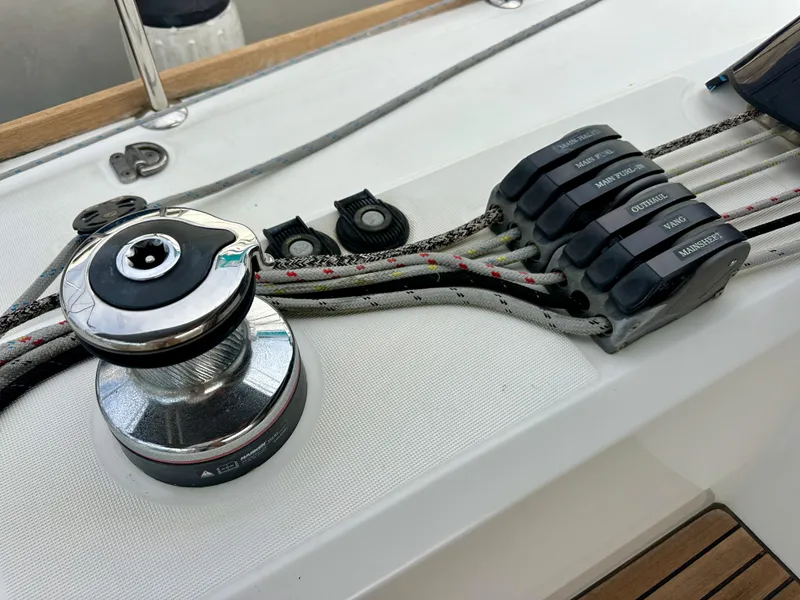 Slide: The Image of Winch and rope clutches on 2012 Beneteau Sense 43 sailboat deck. - 45