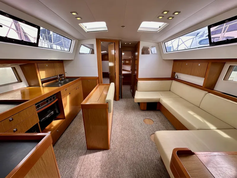 Slide: The Image of Interior of 2012 Beneteau Sense 43 yacht with modern kitchen and seating area. - 49