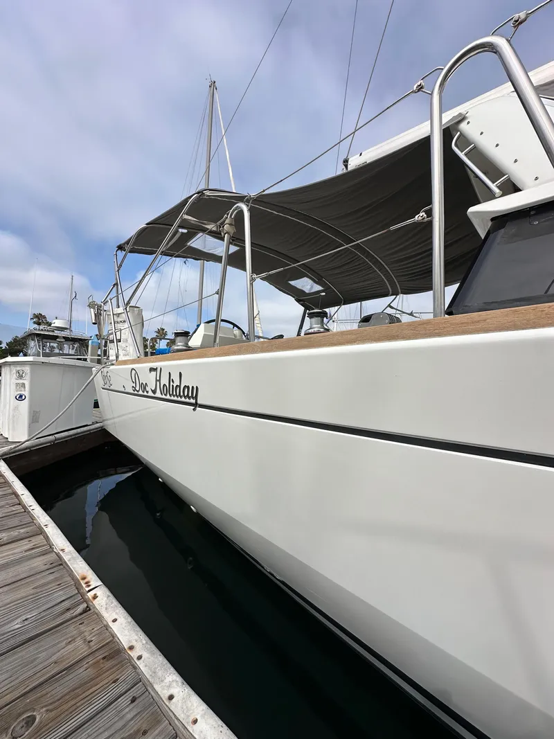 Slide: The Image of 2012 Beneteau Sense 43 yacht docked, featuring sleek design and canopy. - 5