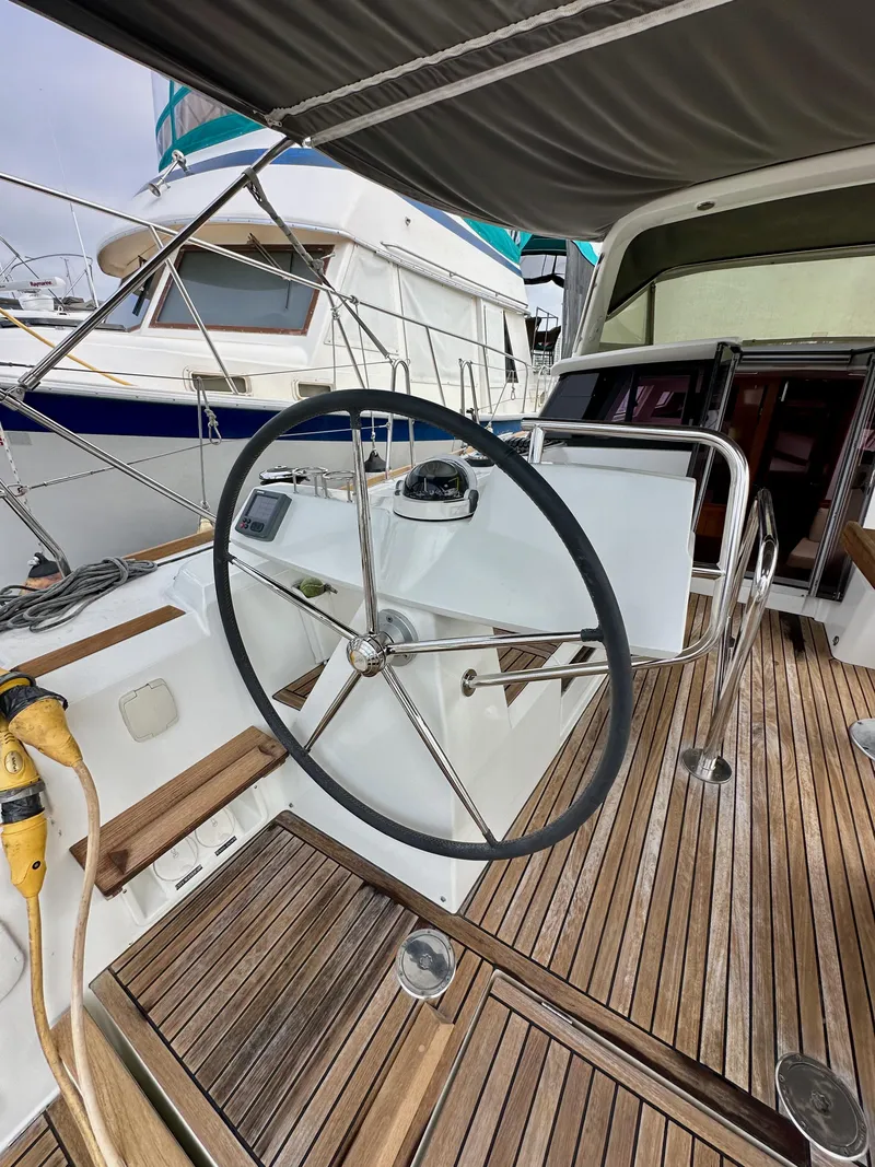 Slide: The Image of Steering wheel of a 2012 Beneteau Sense 43 yacht with wooden deck. - 9