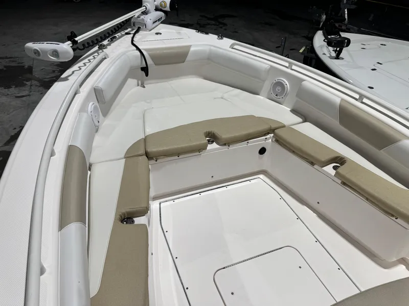 Slide: The Image of 2014 Everglades 243 CC boat interior with cushioned seating and storage compartments. - 11
