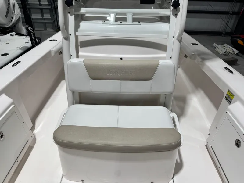 Slide: The Image of 2014 Everglades 243 CC boat interior with cushioned seating and storage compartments. - 14