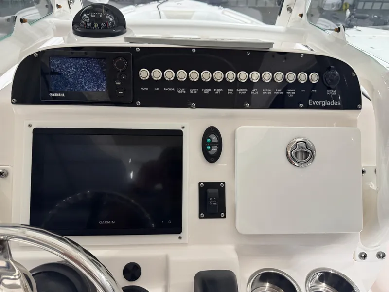 Slide: The Image of Control panel of a 2014 Everglades 243 CC boat with navigation instruments. - 18