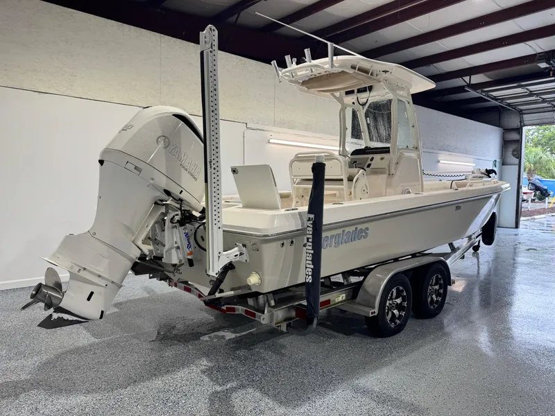 Slide: The Image of 2014 Everglades 243 CC boat with Yamaha outboard engine on trailer in garage. - 2