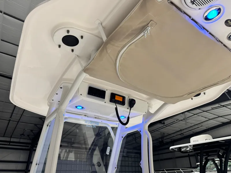 Slide: The Image of 2014 Everglades 243 CC boat interior with blue LED lights and storage compartment. - 22