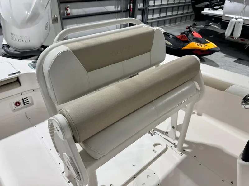 Slide: The Image of 2014 Everglades 243 CC boat interior with beige seating and Yamaha engine in garage. - 7