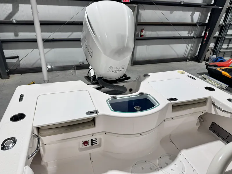 Slide: The Image of 2014 Everglades 243 CC boat interior with Yamaha 300 engine in a garage setting. - 8