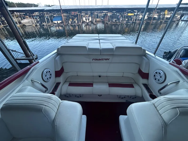 Slide: The Image of 2005 Fountain 42 Executioner boat interior with white seating and marina view. - 12