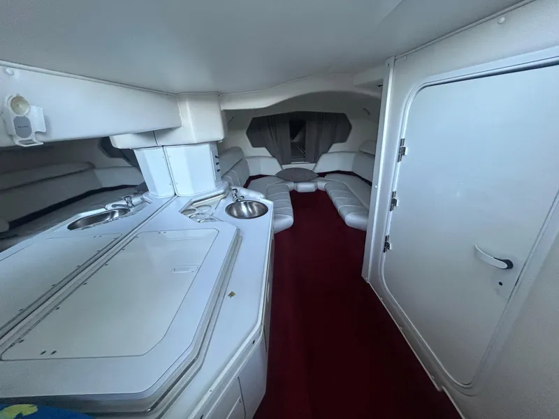 Slide: The Image of Interior of 2005 Fountain 42 Executioner boat with white seating and kitchenette. - 14