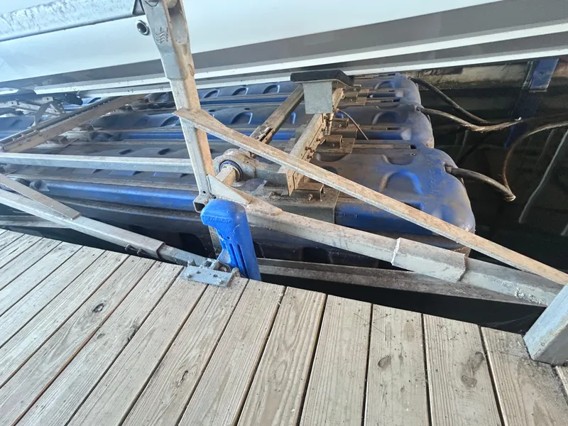 Slide: The Image of 2005 Fountain 42 Executioner engine under maintenance on a wooden dock. - 2