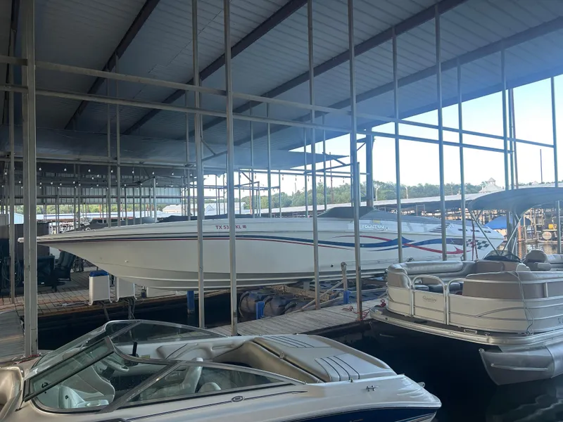 Slide: The Image of 2005 Fountain 42 Executioner speedboat docked in a marina with other boats. - 4