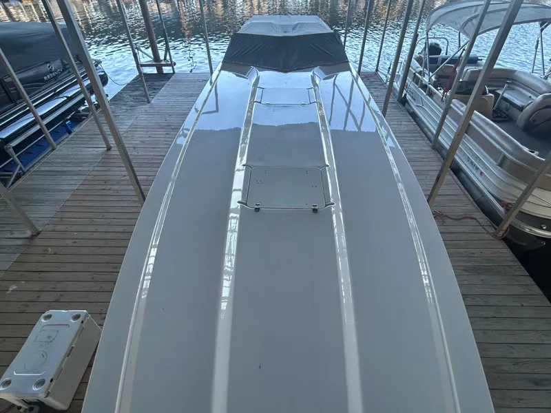 Slide: The Image of 2005 Fountain 42 Executioner boat docked, top view, reflecting water and surrounding boats. - 6