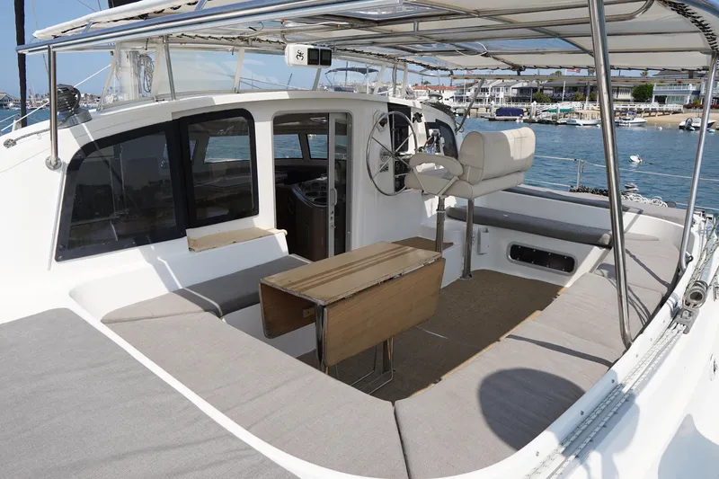 Slide: The Image of 1995 Fountaine Pajot Venezia 42 catamaran with spacious deck and seating area. - 10