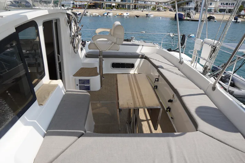 Slide: The Image of Spacious deck of 1995 Fountaine Pajot Venezia 42 catamaran with seating and steering wheel. - 11