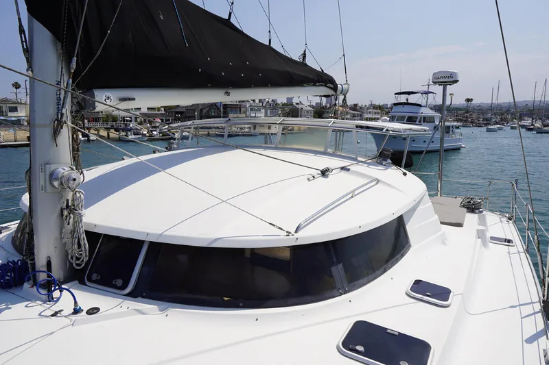 Slide: The Image of Fountaine Pajot Venezia 42 catamaran, 1995 model, docked in a marina with clear skies. - 16