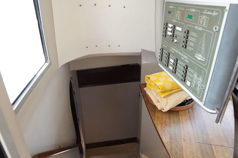 Slide: The Image of Interior of 1995 Fountaine Pajot Venezia 42 yacht with control panel and folded linens. - 18