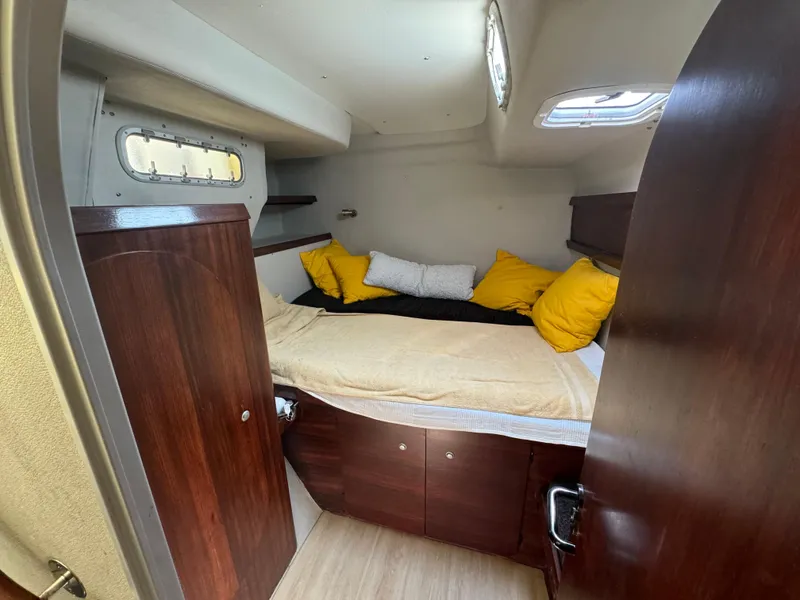 Slide: The Image of Cozy cabin interior of 1995 Fountaine Pajot Venezia 42 with wooden finish and colorful pillows. - 19