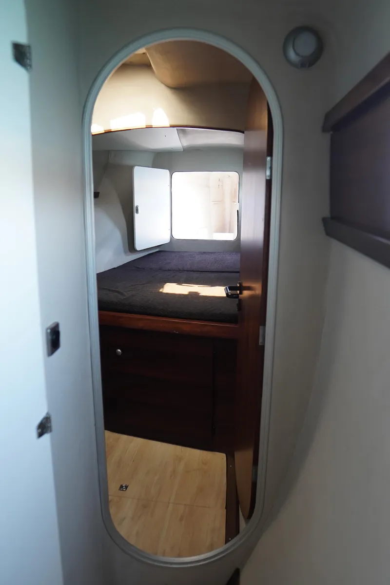 Slide: The Image of Cabin interior of 1995 Fountaine Pajot Venezia 42 catamaran, featuring a cozy bed and window. - 22