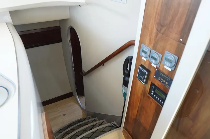 Slide: The Image of Interior of 1995 Fountaine Pajot Venezia 42 yacht, featuring wooden paneling and control gauges. - 24