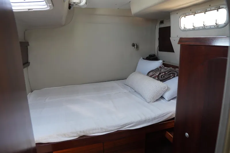 Slide: The Image of Cozy cabin interior of 1995 Fountaine Pajot Venezia 42 catamaran with bed and porthole. - 25