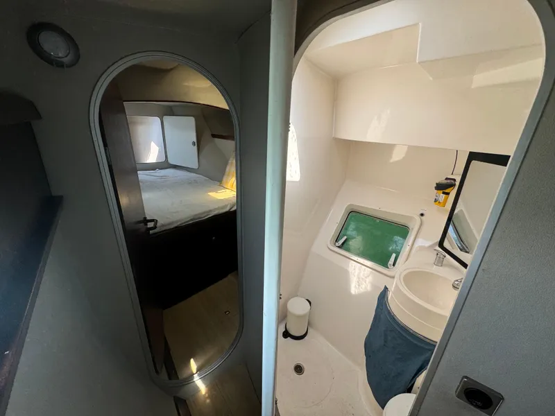 Slide: The Image of Interior of 1995 Fountaine Pajot Venezia 42 catamaran, featuring a cozy cabin and compact bathroom. - 26