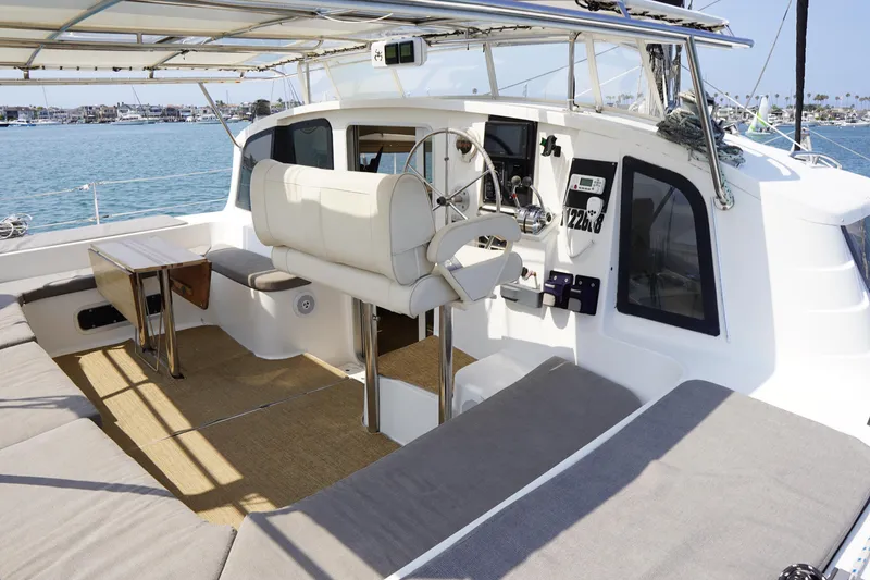 Slide: The Image of 1995 Fountaine Pajot Venezia 42 catamaran cockpit with seating, table, and steering wheel. - 6