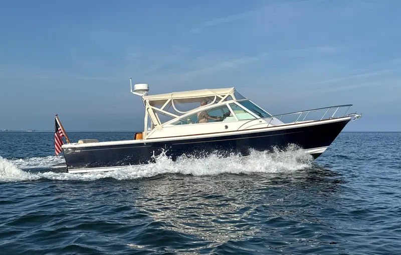 The Image of 2009 Hunt Yachts Harrier 29 cruising with American flag, named "Summer Salt". - 0