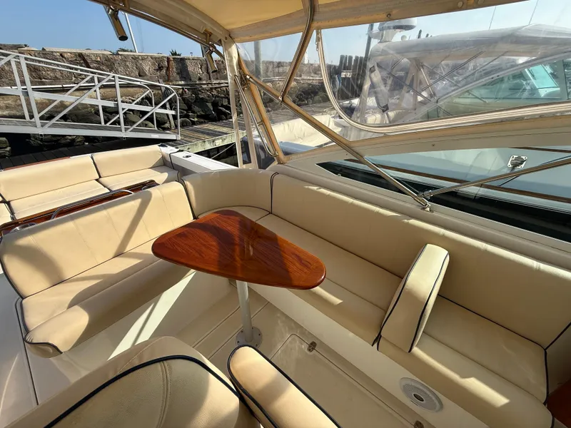 Slide: The Image of 2009 Hunt Yachts Harrier 29 interior with beige seating and wooden table. - 18