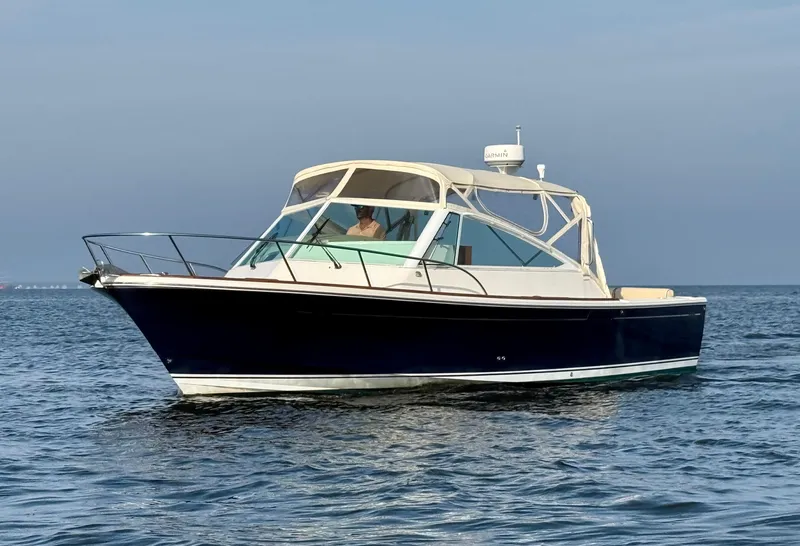 Slide: The Image of 2009 Hunt Yachts Harrier 29 cruising on calm blue waters. - 3