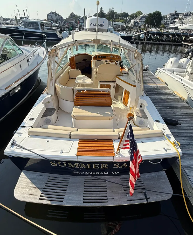 Slide: The Image of 2009 Hunt Yachts Harrier 29 docked, rear view with American flag, luxurious seating. - 13